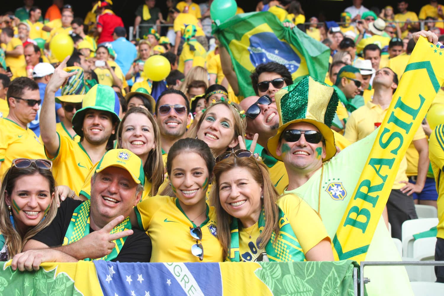 Brazil football supporters in yellow and green checking World Cup kickoff times in BRT.