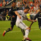 Cristiano Ronaldo dribbles on a football pitch during a European match.