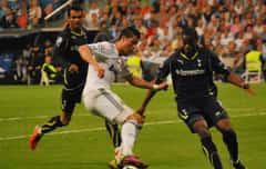 Cristiano Ronaldo dribbles on a football pitch during a European match.